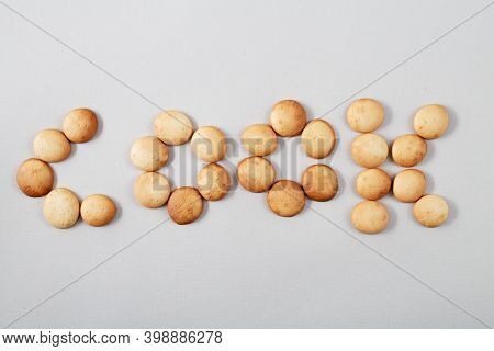 Pattern Of Small Pancakes. Inscription Cook From Orange Toasted Round Biscuits. Home Bakery
