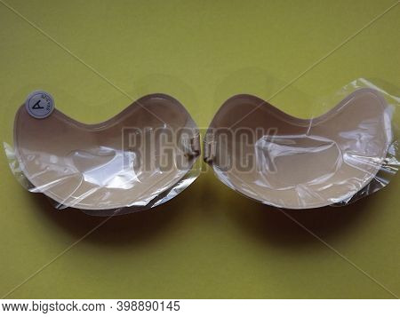 Beige Strapless Bra Close-up On Different Color Backgrounds, Size A. High Quality Photo