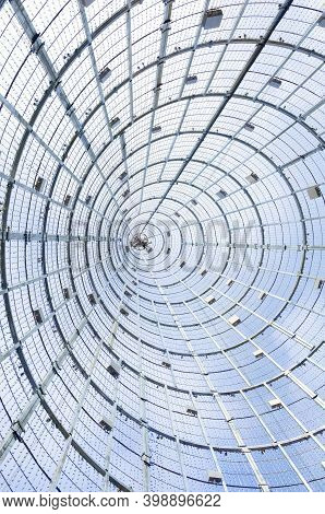 Spiral From A Metal Mesh On A Background Of Sky And Clouds