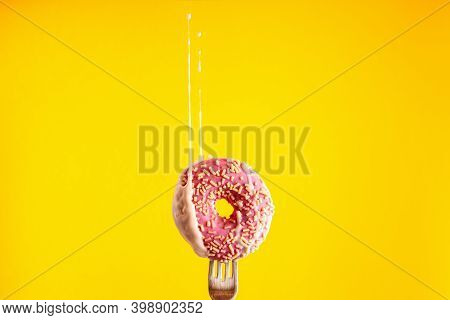 Donut On A Fork. Donut With Freeze-dried Raspberry And A Dymanic Splash Of Pink Glazing