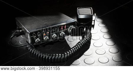 Cb Radio And Microphone On A Rubber Mat With A Dark Background