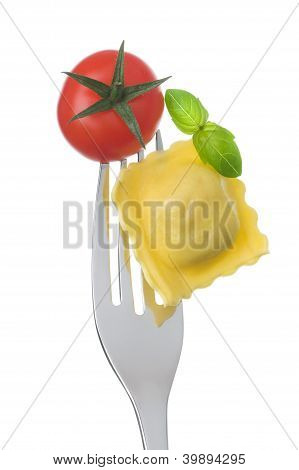 Ravioli Pasta Tomato And Basil On Fork Against White Background