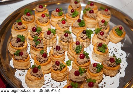 Tartlets Of Cod Liver Pate With Green Leaf Grapes Placed On A Round Plate. Cooking Delicacies, Healt