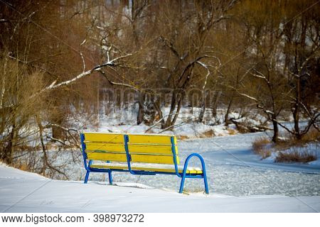 Beautiful Winter Landscape With Frosen River And The Bench Snowy Scene.