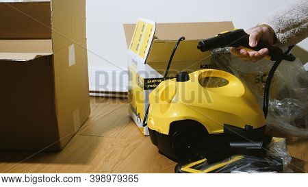 Paris, France - Circa 2019: Real Scene Of Man Unboxing In New House Cardboard Box From Amazon Contai