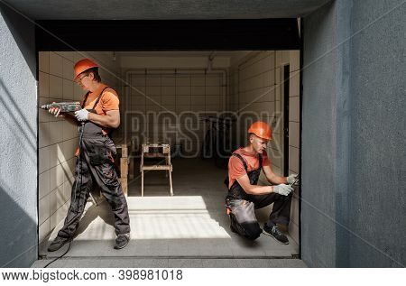 Workers Are Installing Lift Gate In The Garage.