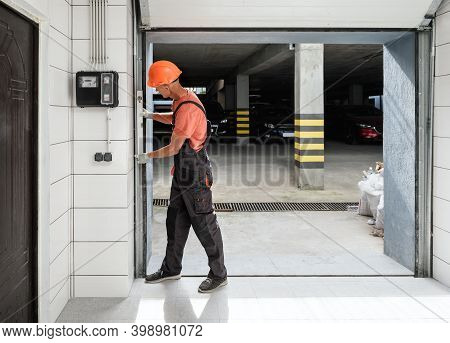 The Worker Is Checking With The Water Level The Vertical Guide Of The Lift Gate.