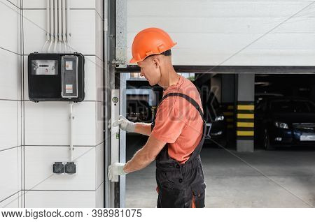 The Worker Is Checking With The Water Level The Vertical Guide Of The Lift Gate.