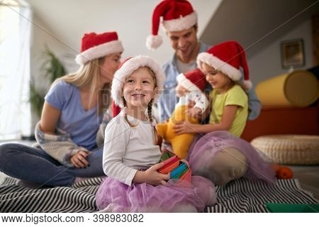 Cheerful parents spening Christmas time together with their kids