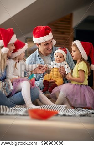 Joyful parents spening Christmas time together with their kids