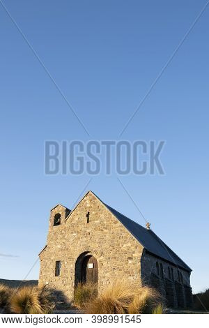 Sun Sets On Stone Front Of Church Of Good Sheppard In Tekapo., Canterbury New Zealand.