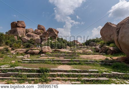 Hampi, Karnataka, India - November 4, 2013: Nandi Monolith Statue Temple And Area. Weeds Overgrow St