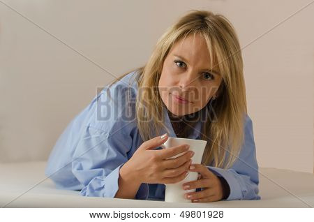 young beautiful woman is drinking coffee