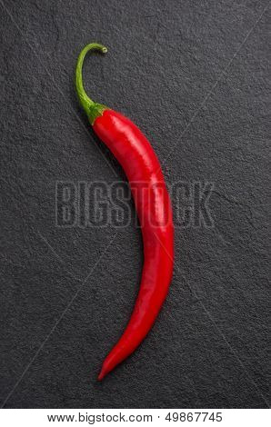 a red chili pepper on slate plate