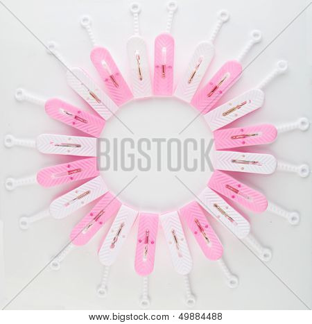 Clothespins arranged as square with whitel background