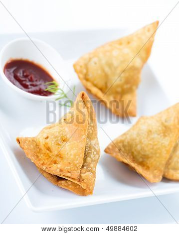 traditional indian snack food samosa with green chutney