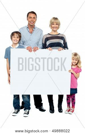 Active Young Family Displaying Blank Ad Board