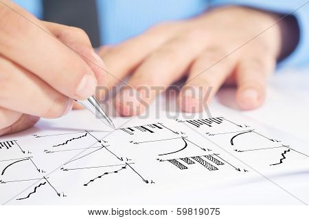 Businessman Drawing Bar Chart And Other Infographics In Note Pad