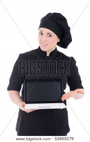 Young Chef Woman In Black Uniform Showing Laptop With Copypaste Isolated On White