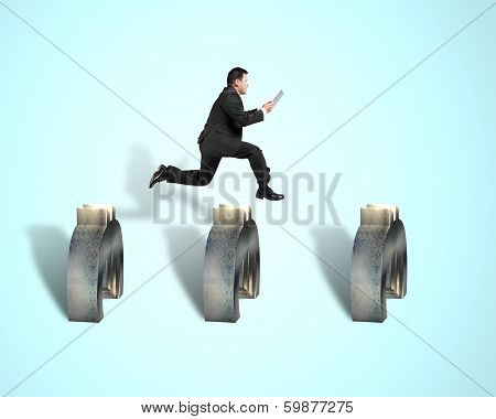 Businessman Jumping Over 3D Euro Symbols