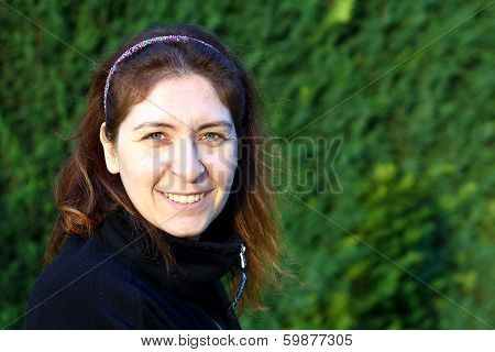 Turkish Women Smiling With A Green Backround