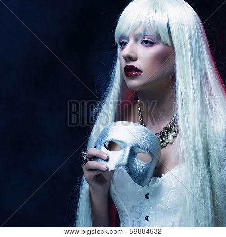 Photo of beautiful woman with silver mask