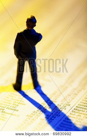 a small figure and the prices of shares in a newspaper. making money in the stock market. gains and losses in stock trading.
