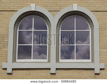 Arched windows with cloud reflection