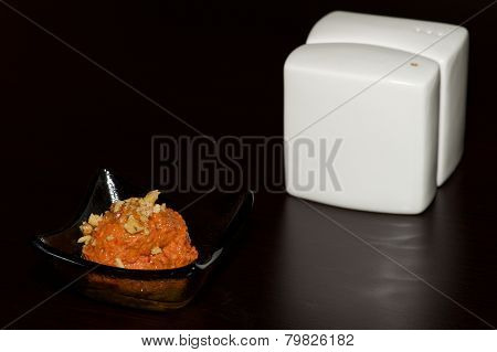 Dish Of Orange Paste Beside White Cruet