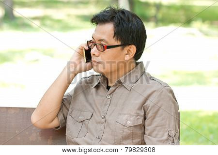 Asiam Man With Mobile Phone In Hand.