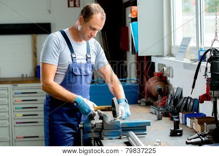 young worker on work bench in the factory
