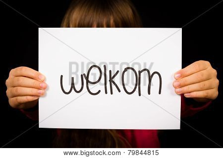 Child Holding Sign With Dutch Word Welkom - Welcome