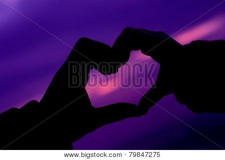 Purple heart symbol made with hands