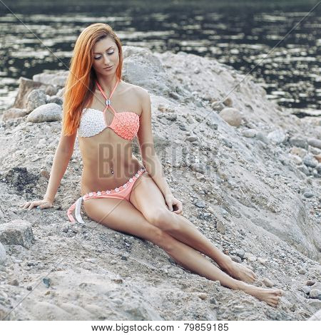 Sexy Girl With Red Hair In A Bikini On The Beach.