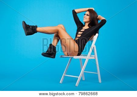 Beautiful Woman In Swimsuit Sitting On A Chair