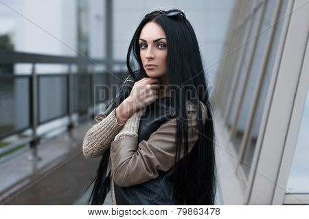 Girl In A Leather Jacket Standing Near The Building