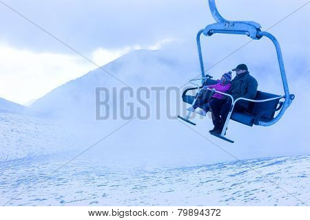 Unidentified Skiers Going Up With A Ski Lift And Enjoying The Last Ski Ride Of The Season In The Fal