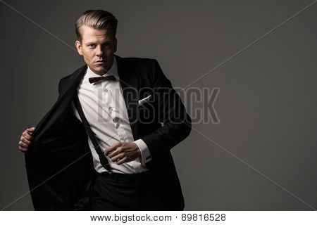 Sharp dressed man wearing jacket and bow tie