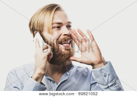 tehnology, internet, emotional  and people concept: young bearded man talking on mobile isolated on white background.Special Fashionable toning.