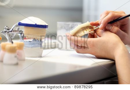 hands working in a dental laboratory, close up