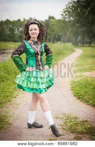 Young Beautiful Girl In Irish Dance Dress And Wig Posing