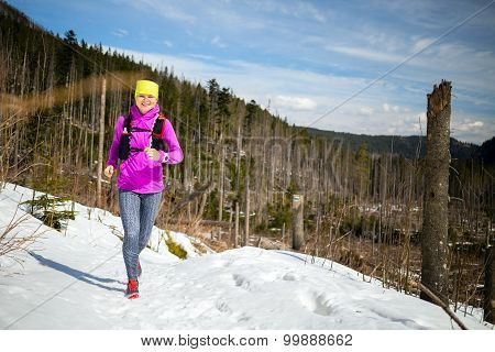 Woman Winter Trail Running In Mountains On Snow