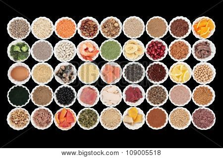 Large health and body building high protein super food with high nutritional values including meat, fish, dairy, pulses, cereals, grains, seeds, supplement powders, fruit and vegetables.