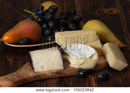 Assorted Cheese On Slate Stone. Grapes, Pears