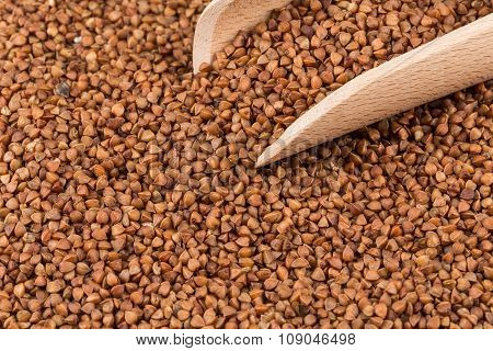 Uncooked Buckwheat On Wooden Spoon