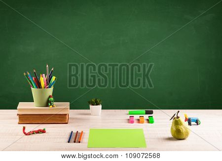 Back to school concepty with clear blackboard background, desk, items