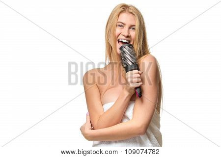 Happy pretty woman in towel singing using comb having fun