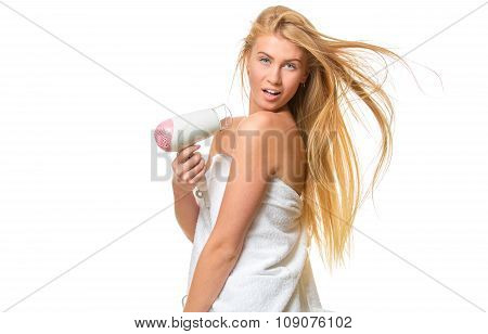 Young blond woman with blue eyes in towel dries hair
