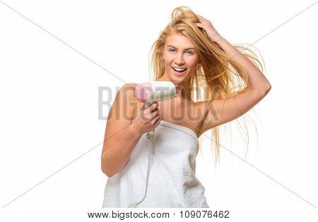 Young blond woman with blue eyes in towel dries hair