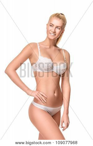 Young blonde woman wearing white underwear isolated over light b